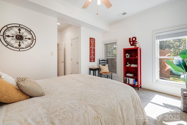 carpeted bedroom featuring multiple windows, ornamental molding, and ceiling fan