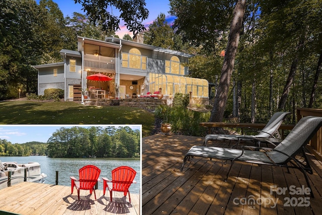 91 Island View Ct, Mill Spring, NC 28756 - rear view of property featuring a lawn, a water view, a chimney, and a balcony