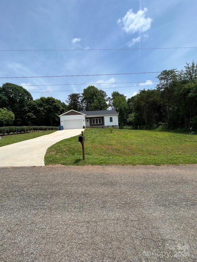 view of front of property featuring a garage and a front lawn