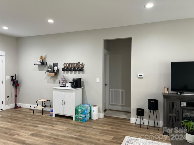 interior space featuring white cabinets and hardwood / wood-style floors