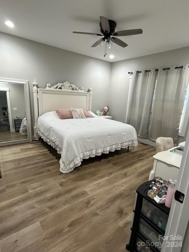 bedroom featuring dark hardwood / wood-style flooring and ceiling fan