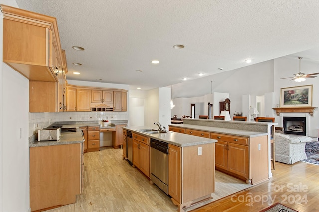 kitchen with ceiling fan, dishwasher, sink, an island with sink, and light hardwood / wood-style floors