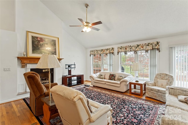 living room featuring wood-type flooring, high vaulted ceiling, plenty of natural light, and ceiling fan