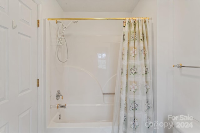 bathroom with shower / bath combination with curtain