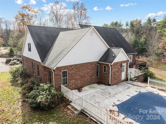 view of property exterior featuring a covered pool