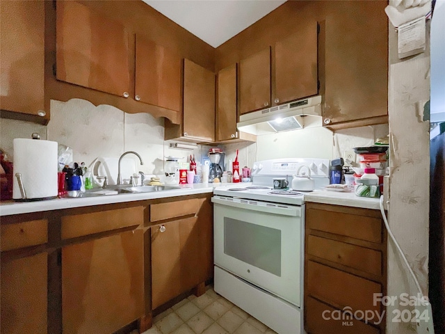 kitchen with white electric range oven and sink