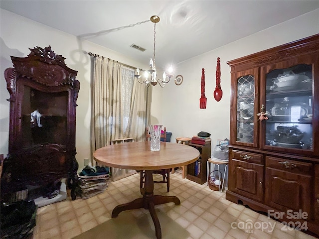 dining area with an inviting chandelier