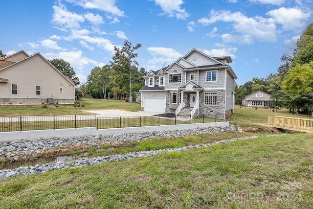 craftsman-style home with a garage, a front yard, and central AC