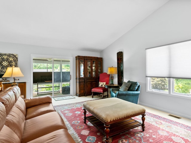 living room with lofted ceiling and carpet flooring