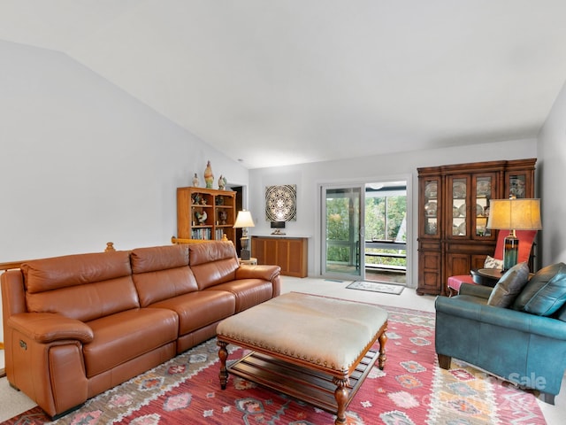 carpeted living room featuring vaulted ceiling