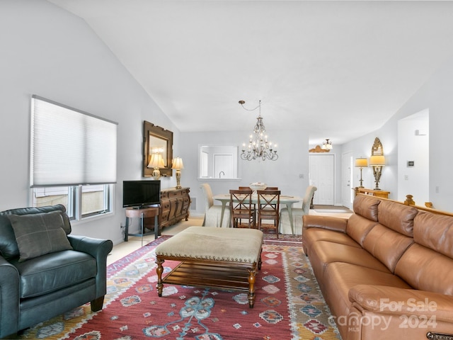 living room featuring a notable chandelier and lofted ceiling