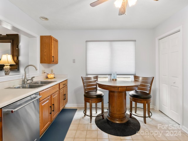 kitchen featuring ceiling fan, dishwasher, sink, and light tile patterned flooring