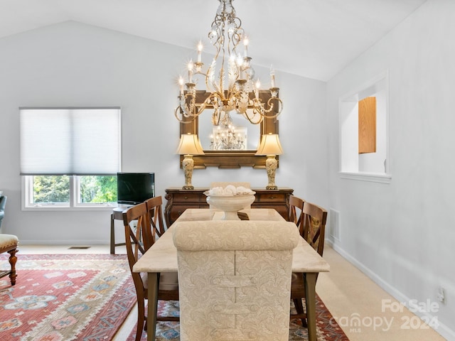 carpeted dining area with an inviting chandelier and vaulted ceiling