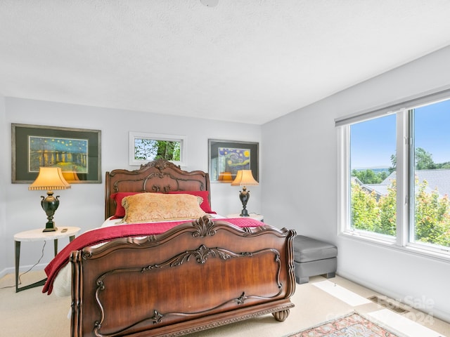 carpeted bedroom featuring a textured ceiling