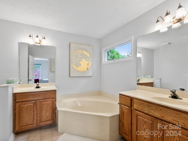 bathroom featuring vanity, tile patterned floors, and a washtub