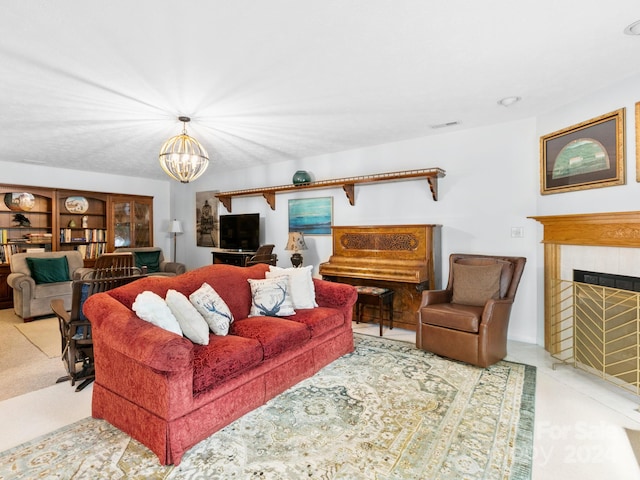 carpeted living room with a notable chandelier and a tile fireplace