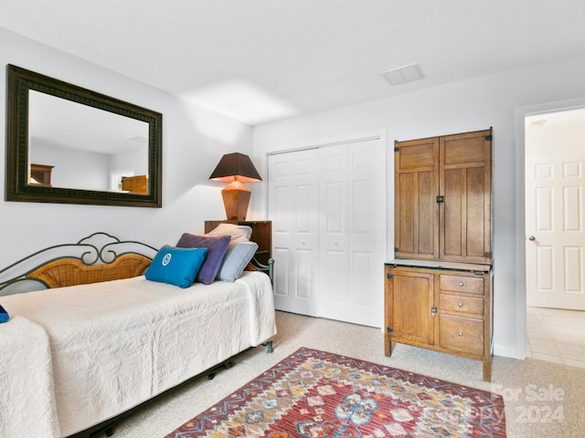 carpeted bedroom with a closet