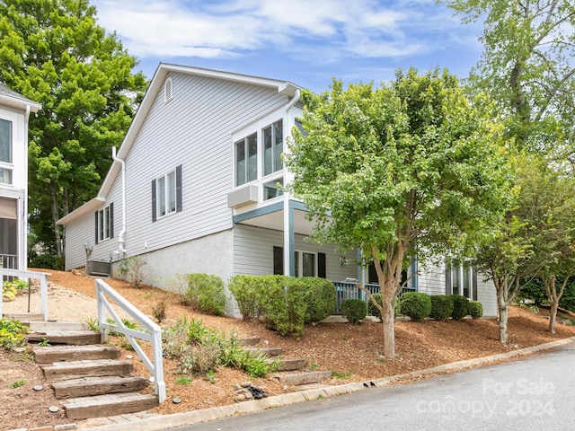 view of front of house featuring cooling unit and covered porch