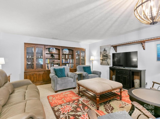 carpeted living room with a textured ceiling and a chandelier