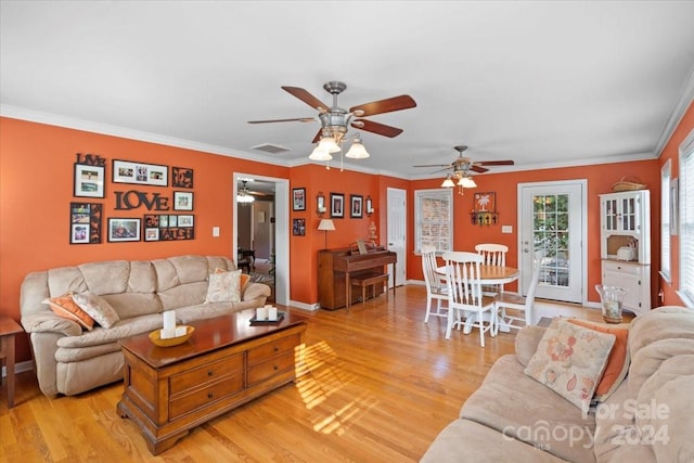 living room with ceiling fan, ornamental molding, and light hardwood / wood-style floors