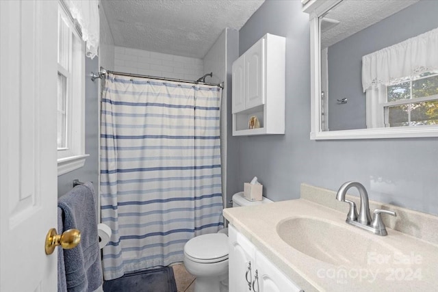 bathroom with a textured ceiling, vanity, toilet, and a shower with curtain