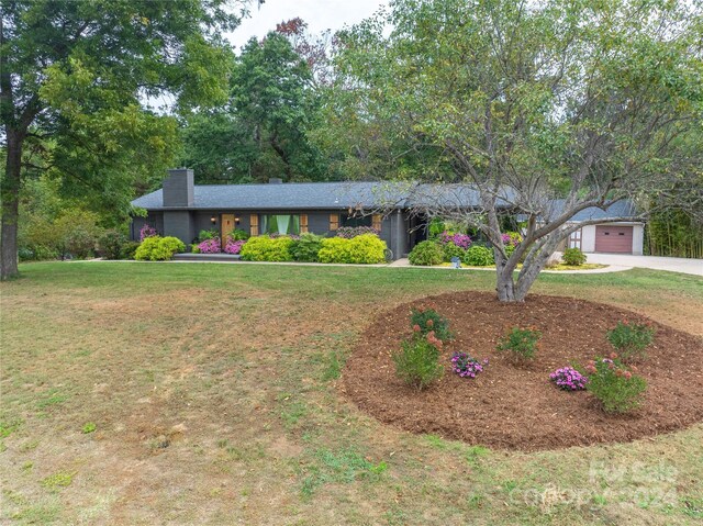 ranch-style home with a garage and a front yard