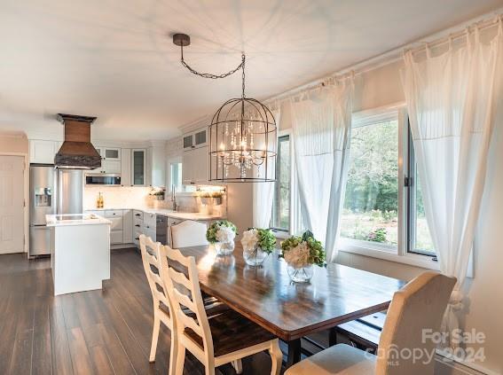 dining space with a notable chandelier and dark hardwood / wood-style floors