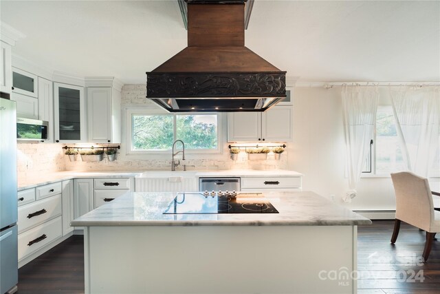 kitchen with custom range hood, dark hardwood / wood-style flooring, and a kitchen island