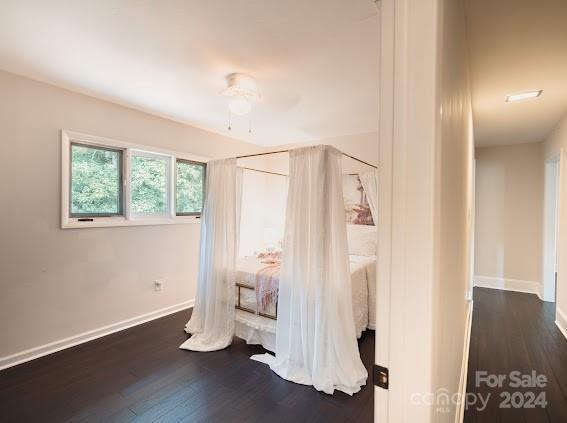 bedroom with ceiling fan and dark hardwood / wood-style flooring