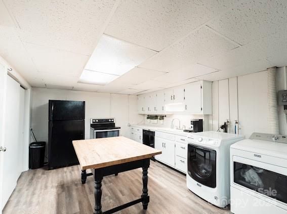 interior space featuring washer and clothes dryer and light hardwood / wood-style flooring