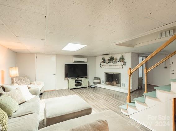 living room with wood-type flooring and a wall mounted AC