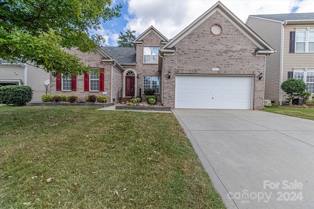 front facade with a front lawn and a garage