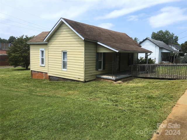 rear view of property with a lawn