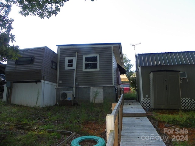 back of property with a storage unit and ac unit