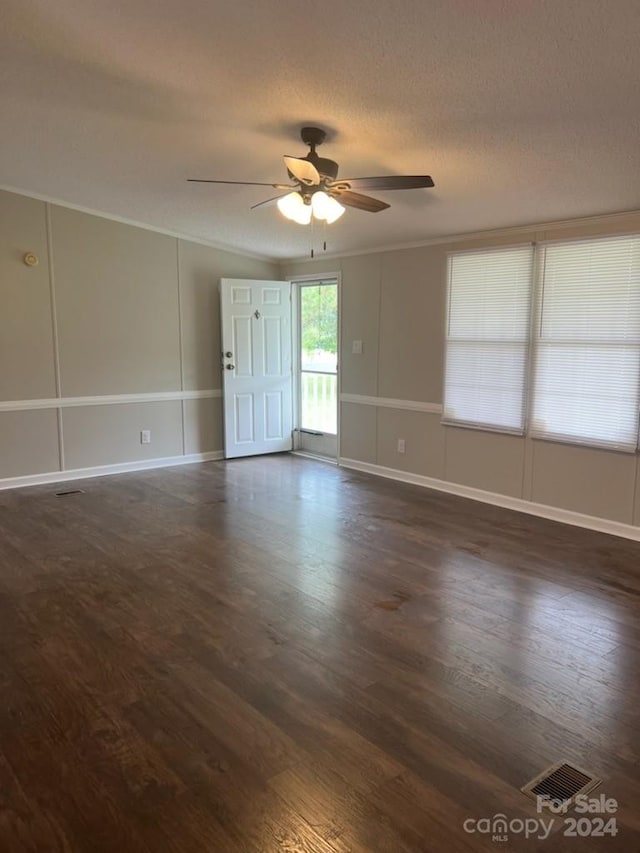 unfurnished room with dark wood-type flooring, a textured ceiling, and ceiling fan