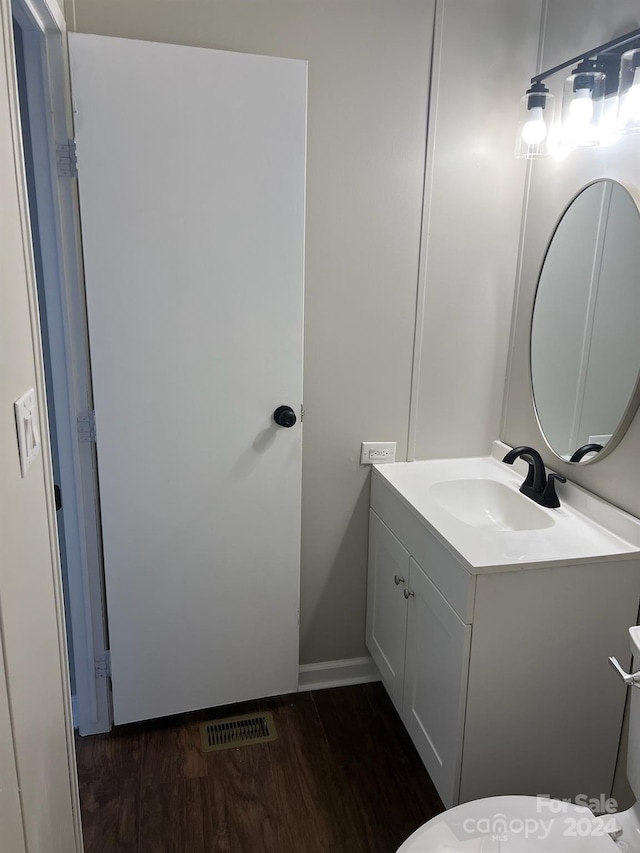 bathroom featuring vanity, toilet, and wood-type flooring