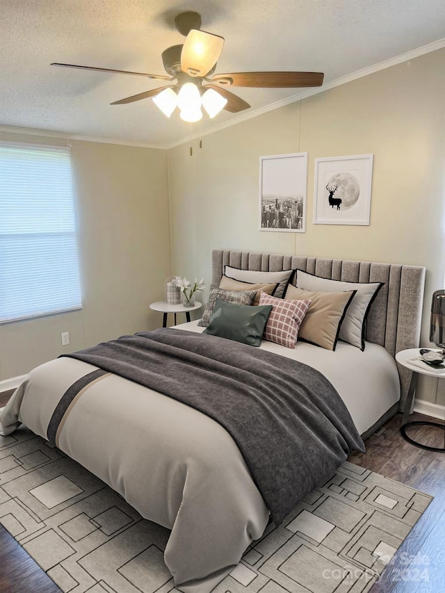 bedroom featuring ceiling fan, a textured ceiling, light wood-type flooring, vaulted ceiling, and crown molding