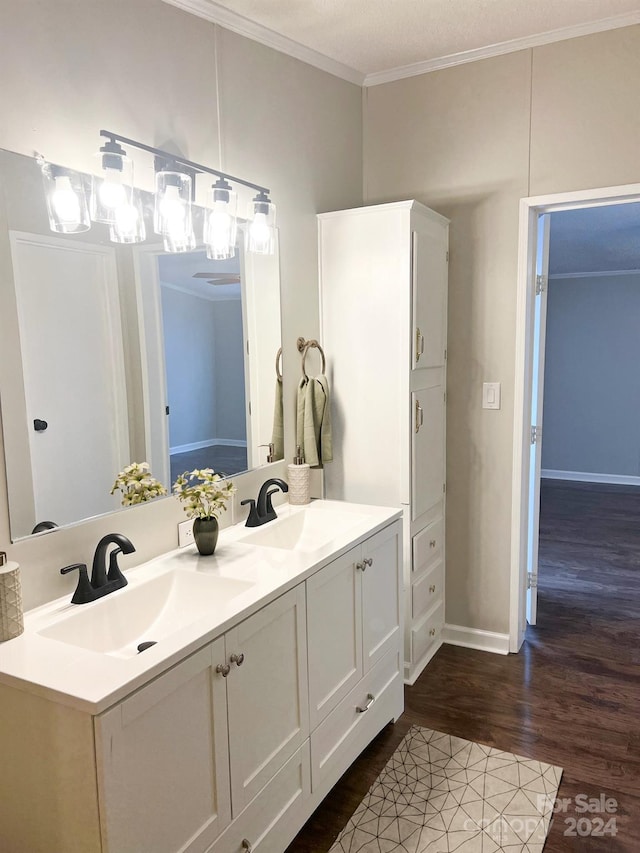 bathroom with vanity, crown molding, and wood-type flooring