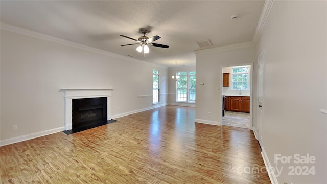 unfurnished living room featuring hardwood / wood-style floors, ceiling fan with notable chandelier, ornamental molding, and sink