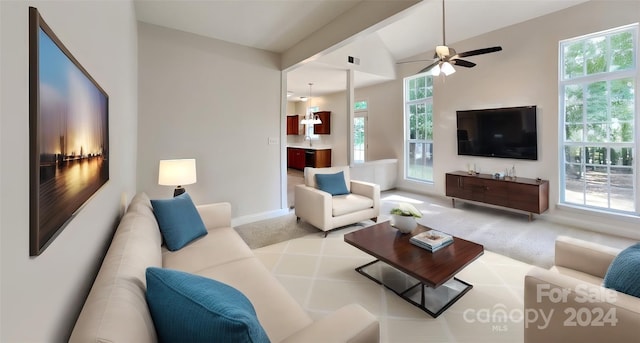 carpeted living room featuring ceiling fan, plenty of natural light, and vaulted ceiling