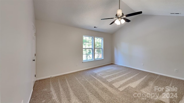 carpeted empty room with ceiling fan and vaulted ceiling