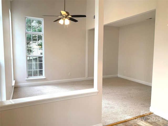 spare room featuring carpet floors and ceiling fan