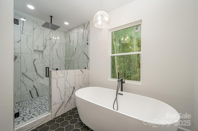 full bathroom with a soaking tub, a marble finish shower, and recessed lighting