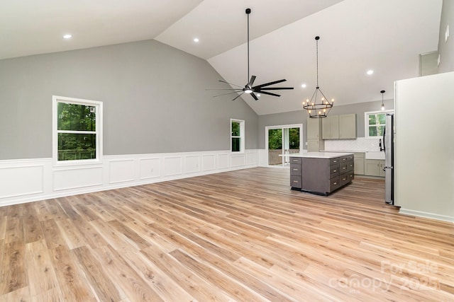 kitchen featuring light wood finished floors, light countertops, freestanding refrigerator, open floor plan, and a kitchen island