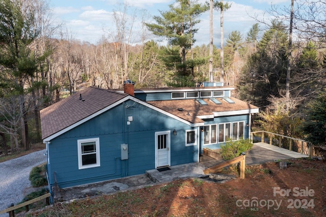 back of property featuring a patio area and a sunroom