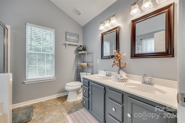 bathroom with lofted ceiling, toilet, and vanity