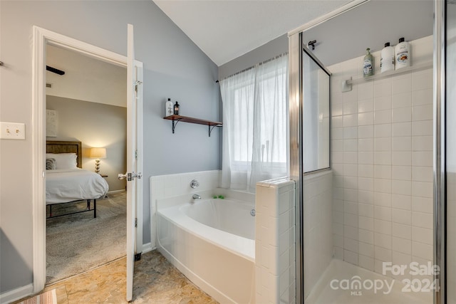 bathroom featuring vaulted ceiling and shower with separate bathtub