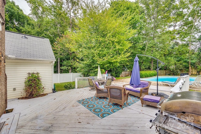 wooden terrace with a fenced in pool