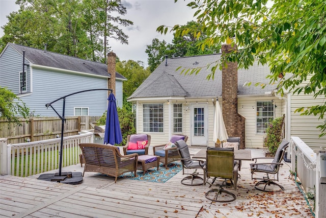 deck with an outdoor living space with a fire pit