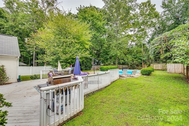 view of yard with a pool side deck